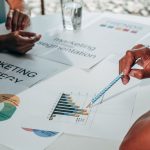 Team working on marketing strategy using data charts and papers in an office meeting. — "A Guide to Effective Content Marketi