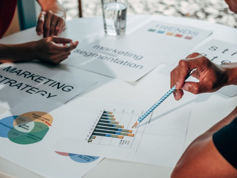 Team working on marketing strategy using data charts and papers in an office meeting. — "A Guide to Effective Content Marketi