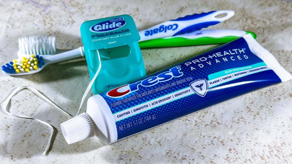 Close-up of dental care items including toothbrush, floss, and toothpaste for oral hygiene. — Exploring the Techniques Behind