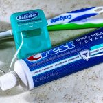 Close-up of dental care items including toothbrush, floss, and toothpaste for oral hygiene. — Exploring the Techniques Behind