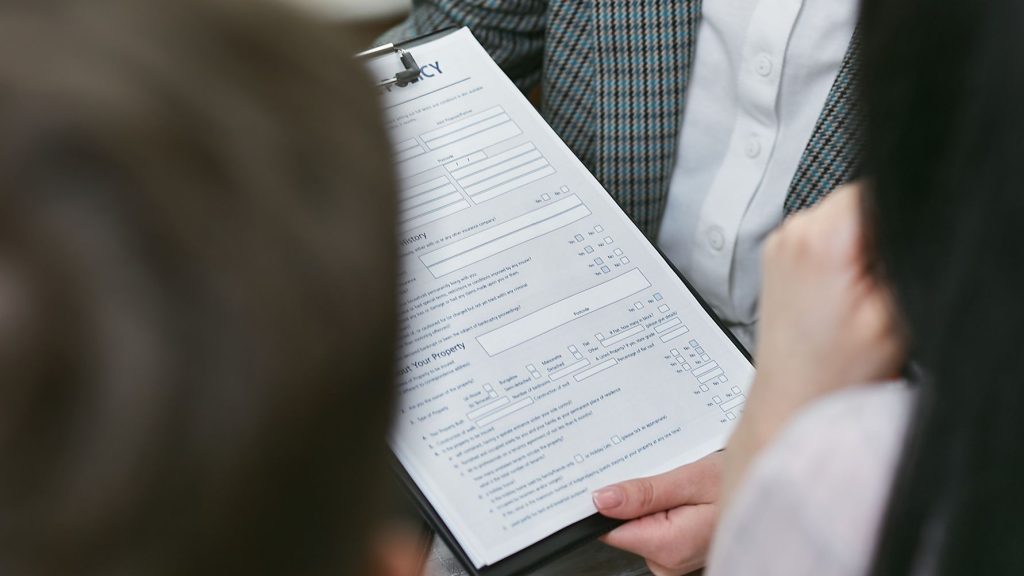 Close-up of professionals discussing a legal contract during a business meeting. — "How to Avoid Common Mistakes During Marke