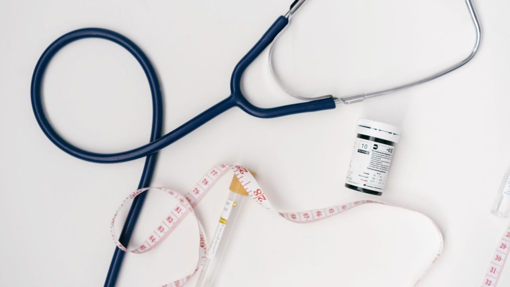 Flat lay of medical tools including stethoscope and measuring tape on a white background. — The Benefits of Using Hair, Skin,