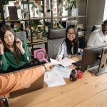 Diverse call center team collaborating at a modern workspace, showcasing teamwork and communication. — The Pros and Cons of F