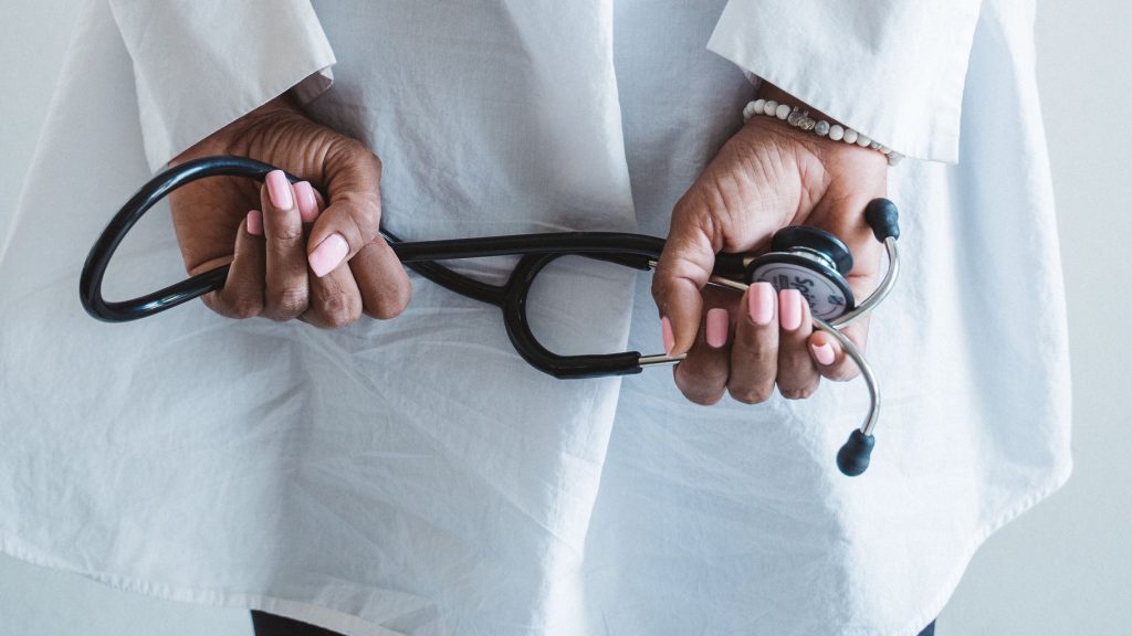 A medical professional holding a stethoscope in a clinical setting. — Ultra: Elevate Your Workouts with Enhanced Performance