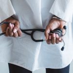 A medical professional holding a stethoscope in a clinical setting. — Ultra: Elevate Your Workouts with Enhanced Performance